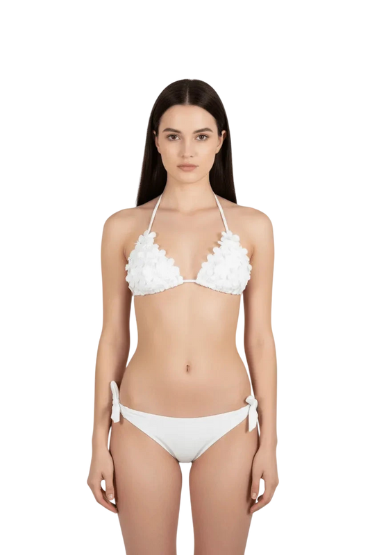 A white triangle bikini with floral embellishments on the cups and side-tie bottoms.