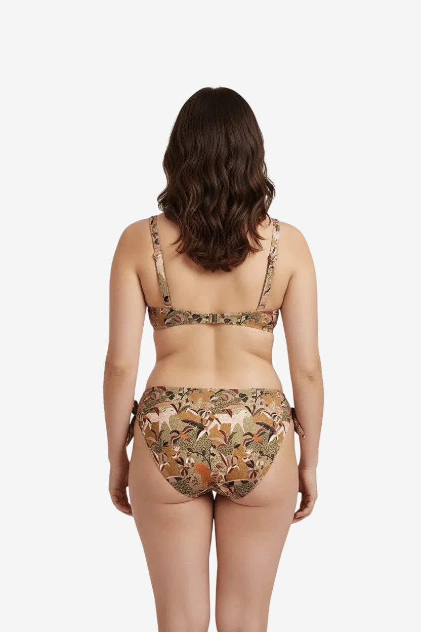 A woman seen from behind wearing a brown patterned bikini with a tie-side bottom.