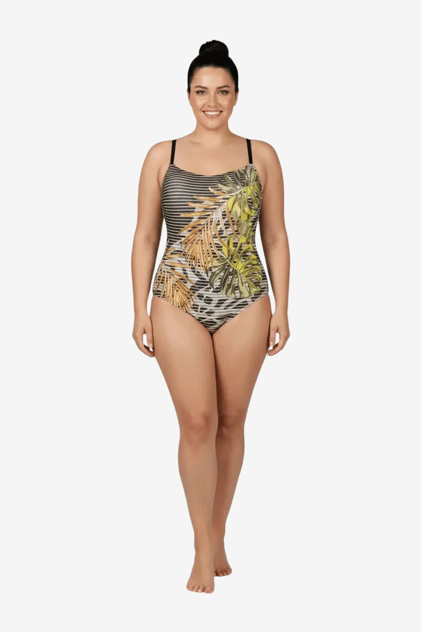 Costume intero con stampa a foglie tropicali su fondo a righe orizzontali.