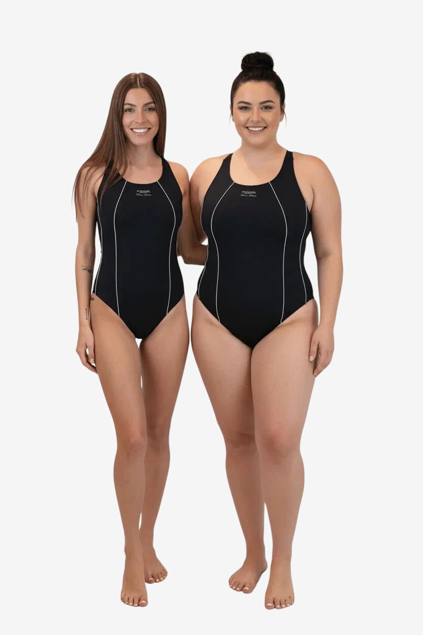 Two women wearing black one-piece swimsuits with white piping details against a white background.