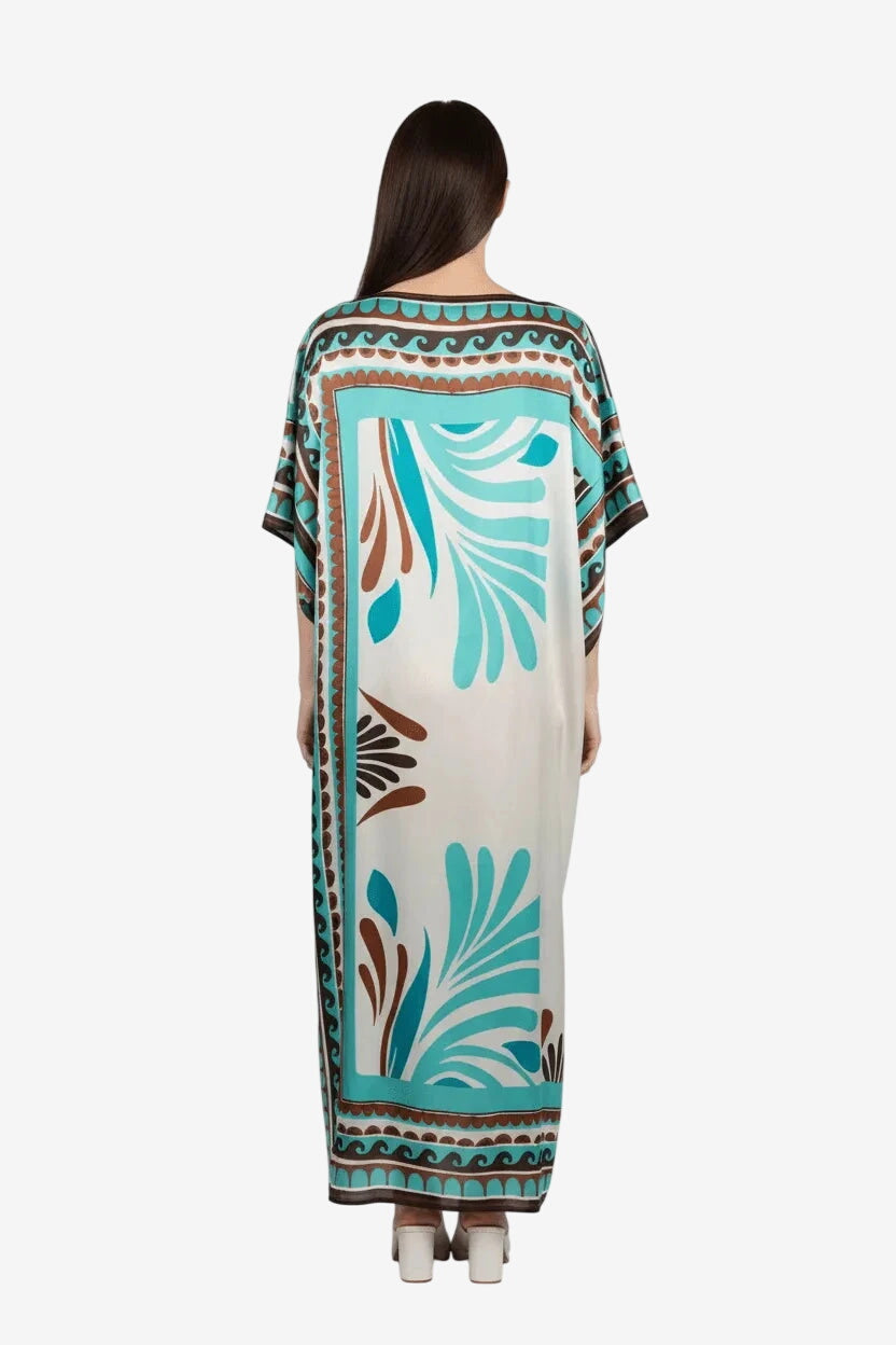 Poncho lungo in seta e viscosa con fantasia tribale nei toni del turchese e marrone.