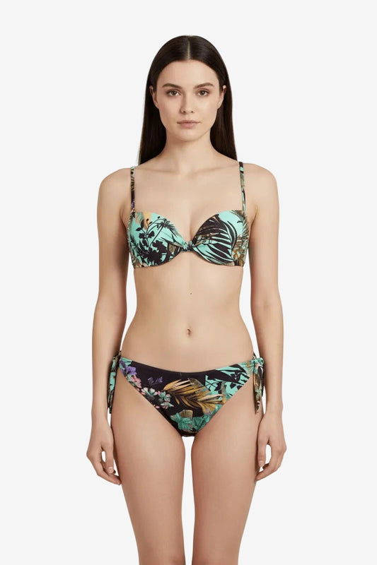 A woman wears a push-up bikini set featuring a tropical leaf print in shades of teal and black.