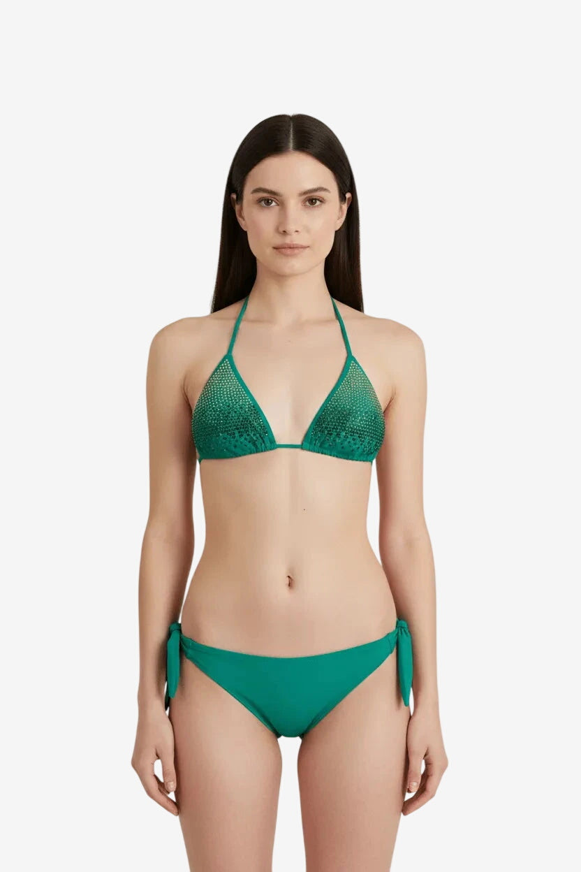 A woman wears a green triangle bikini top embellished with small studs and matching side-tie bottoms.