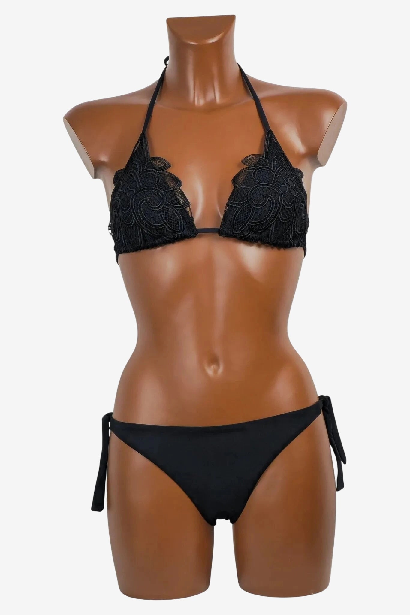 A black bikini set featuring a triangle top with intricate lace detailing and side-tie bottoms.