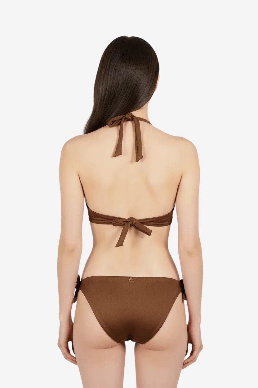 A woman from behind wearing a brown bikini with tie closures on the top and sides.