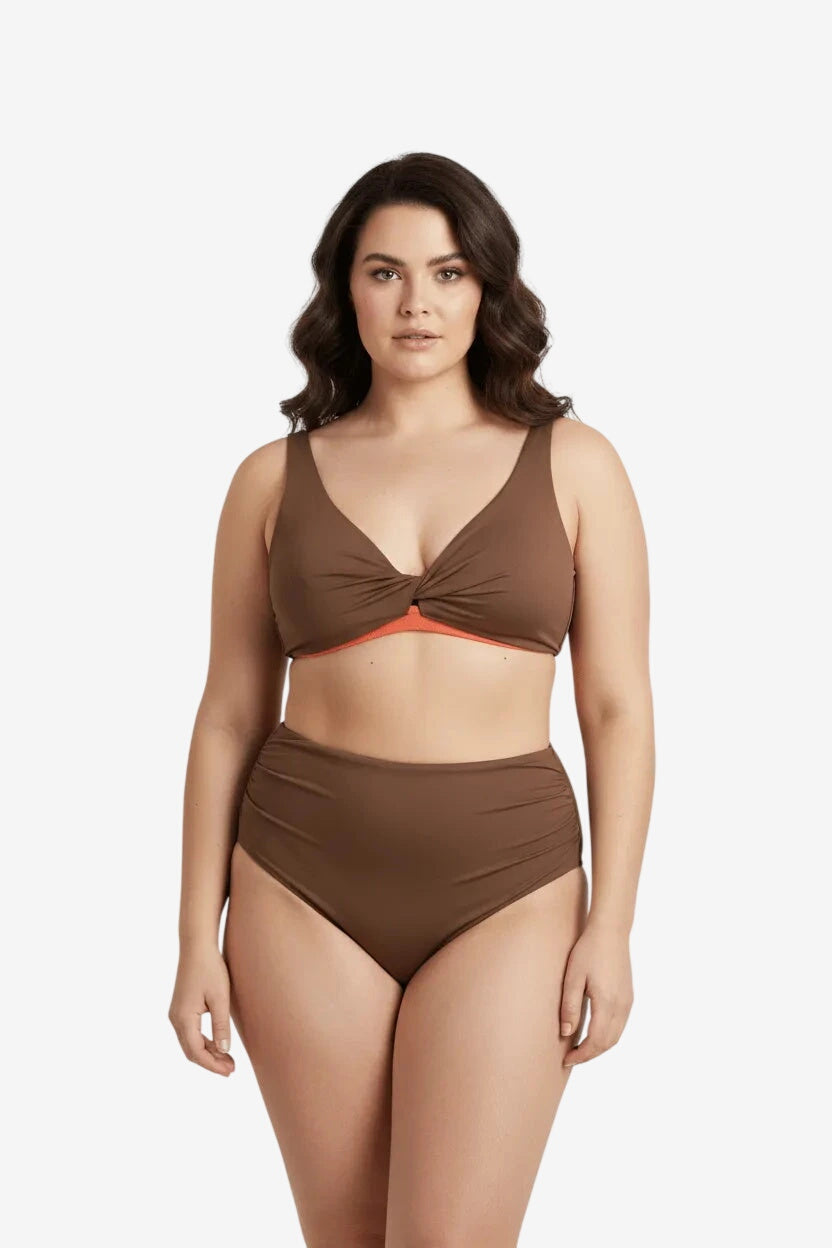 A model wears a brown two-piece bikini with a twisted front top and high-waisted bottoms.